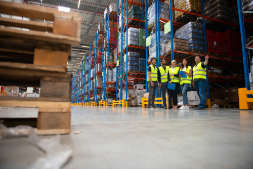 Group discussion in warehouse about inventory tracking and efficieny using a barcode data collection solution